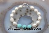 CFB943 Hand-knotted 9mm - 10mm rice white freshwater pearl & blue howlite bracelet