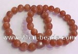 CGB4540 7.5 inches 10mm - 11mm round golden sunstone beaded bracelets