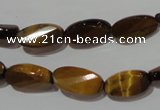 CTE1097 15.5 inches 8*15mm twisted & faceted oval yellow tiger eye beads